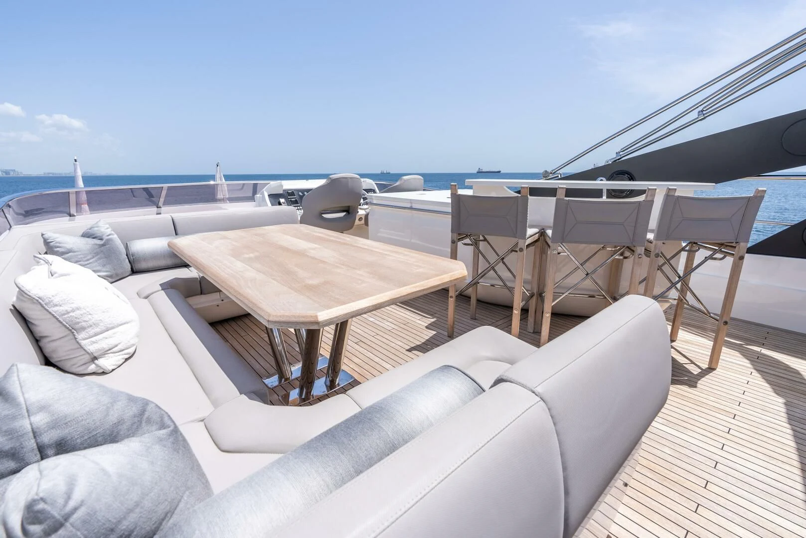 a couch and table on a deck aboard F5 Yacht for Sale