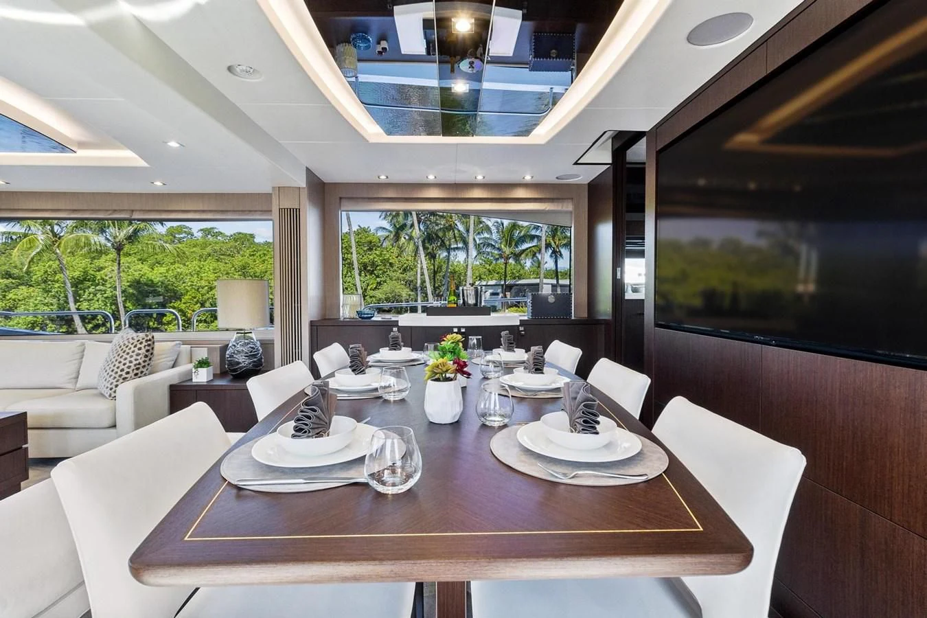 a large dining table in a room aboard F5 Yacht for Sale