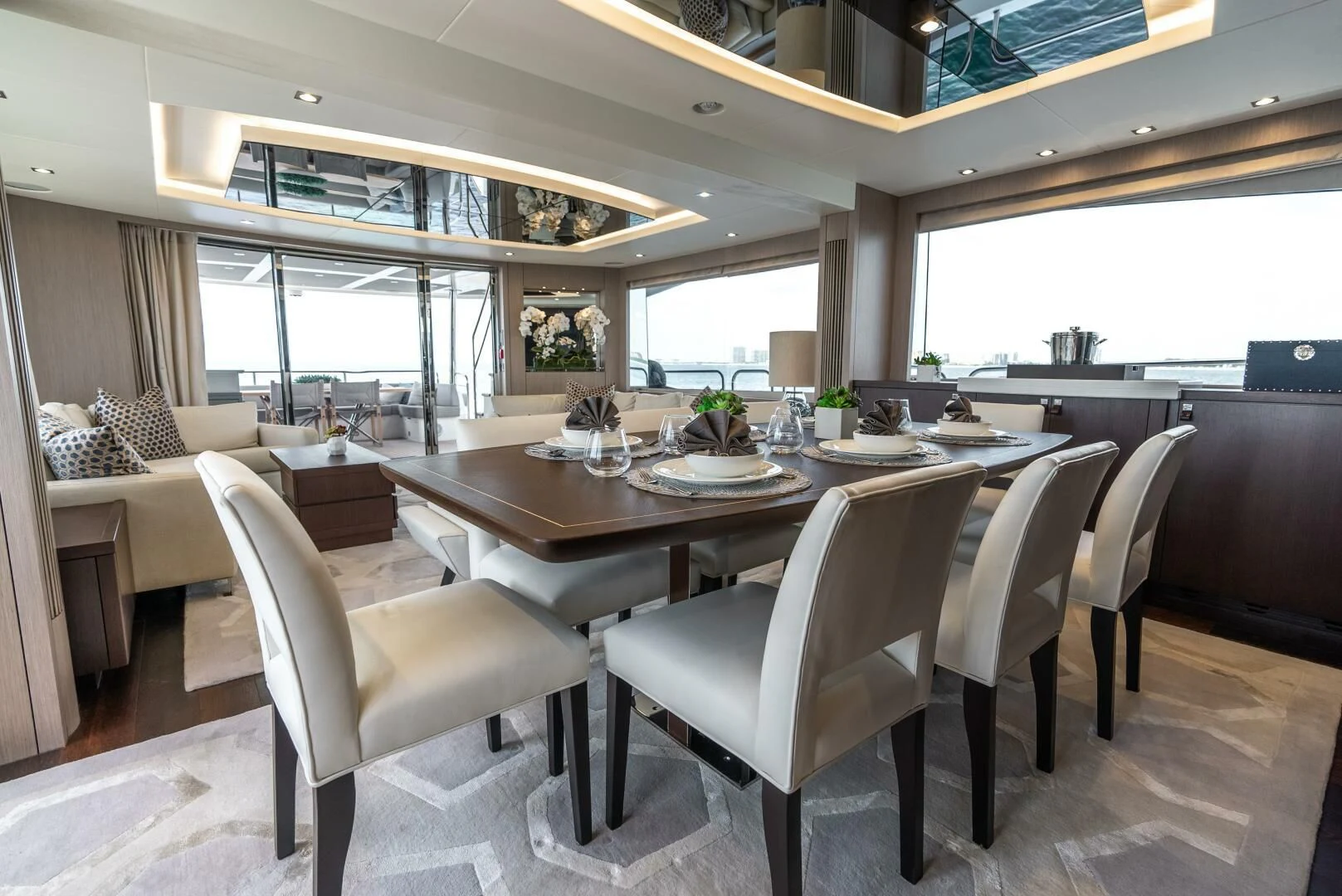 a large dining table with chairs around it aboard F5 Yacht for Sale