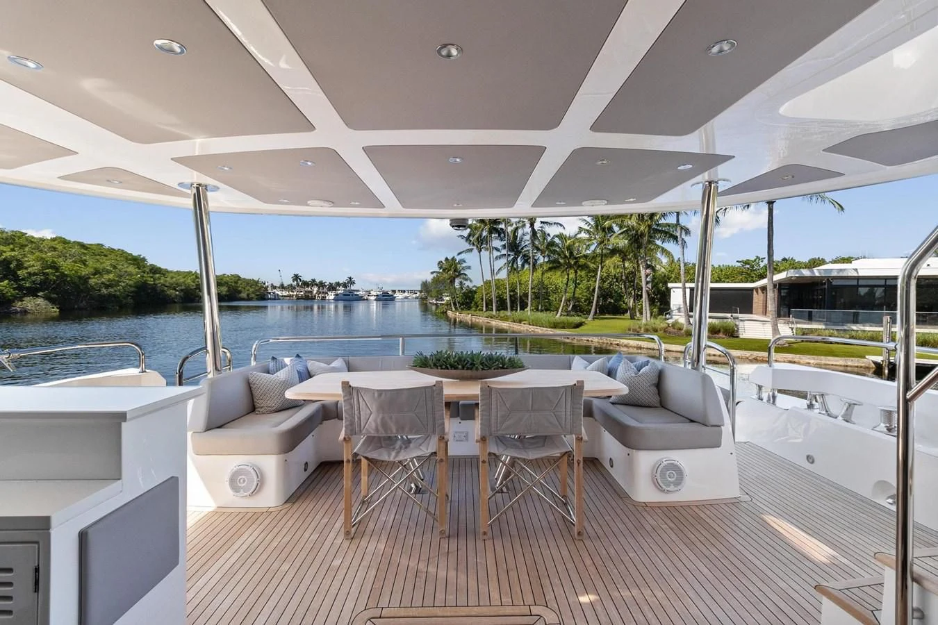 a patio with a table and chairs aboard F5 Yacht for Sale