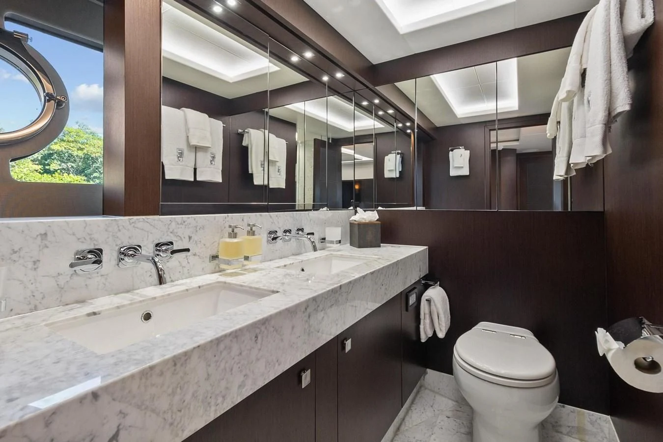 a bathroom with a sink toilet and a mirror aboard F5 Yacht for Sale