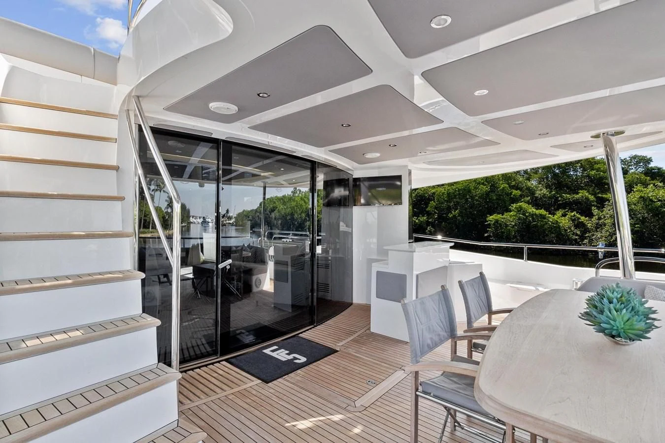 a glass walled room with a table and chairs aboard F5 Yacht for Sale