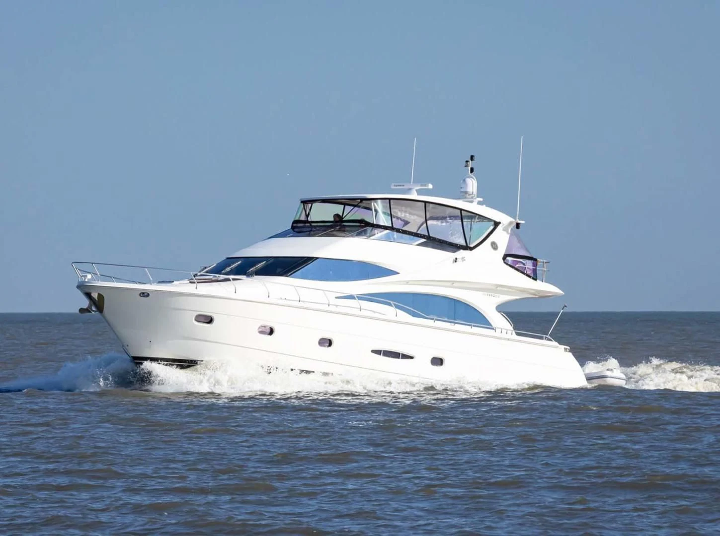 a white yacht in the water aboard DECKED OUT Yacht for Sale