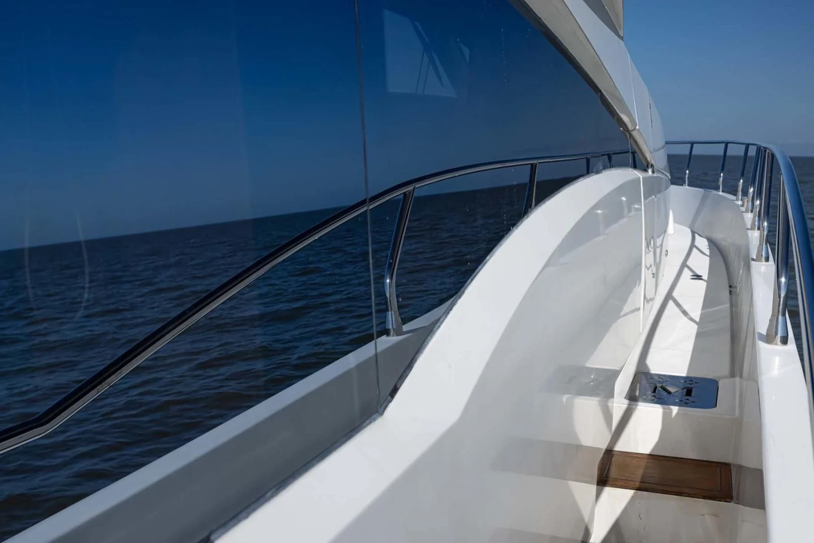 a white boat on a blue water aboard DECKED OUT Yacht for Sale