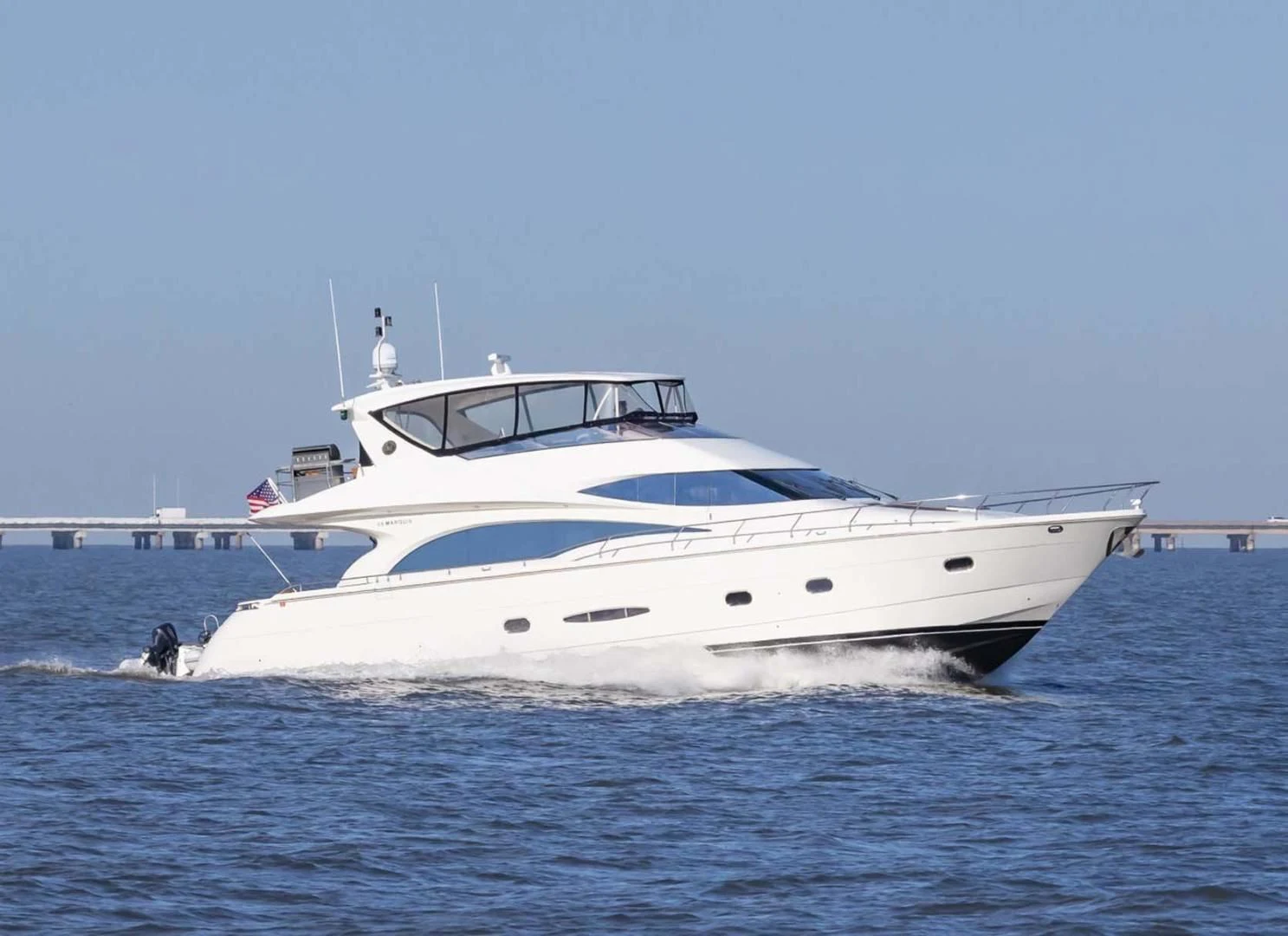 a white yacht in the water aboard DECKED OUT Yacht for Sale
