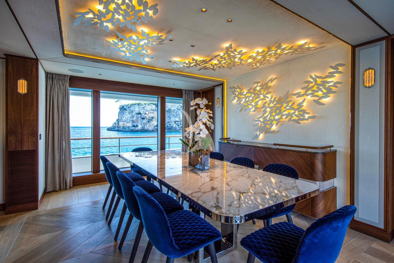 a dining room with a large window aboard DELTA ONE Yacht for Charter