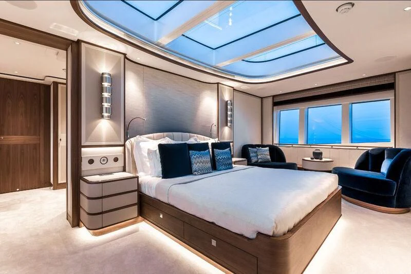 a large bedroom with a bed and a couch aboard DELTA ONE Yacht for Charter