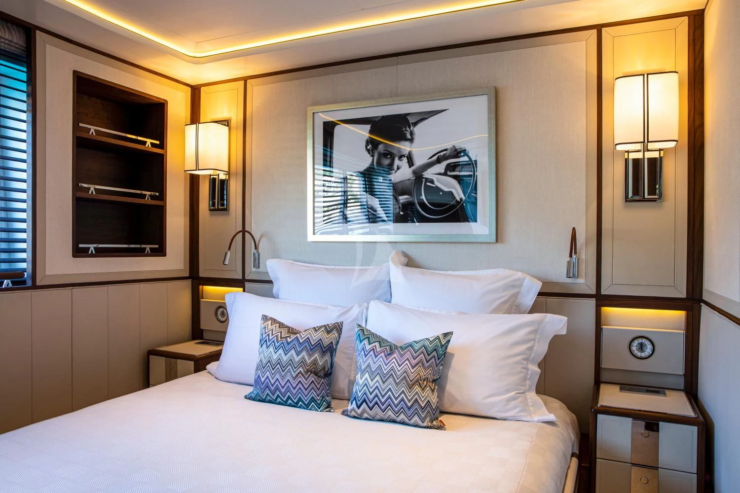 a bed with pillows and a television aboard DELTA ONE Yacht for Charter