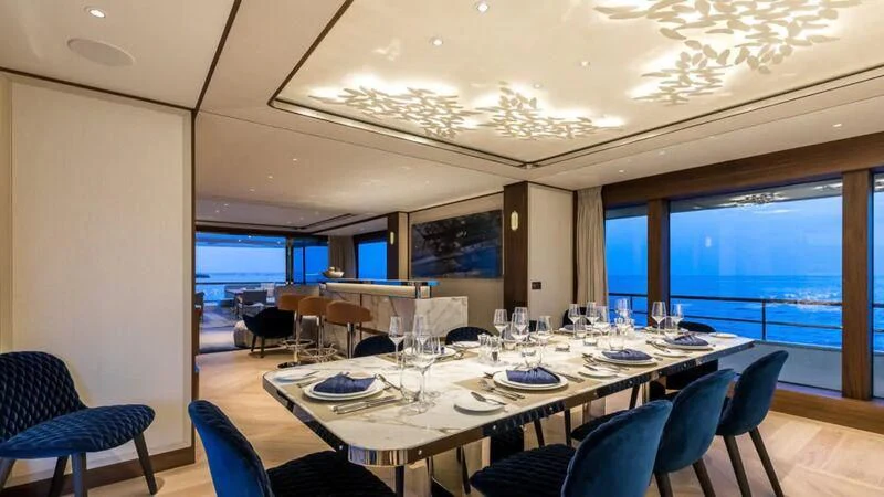 a large conference room with tables and chairs aboard DELTA ONE Yacht for Charter