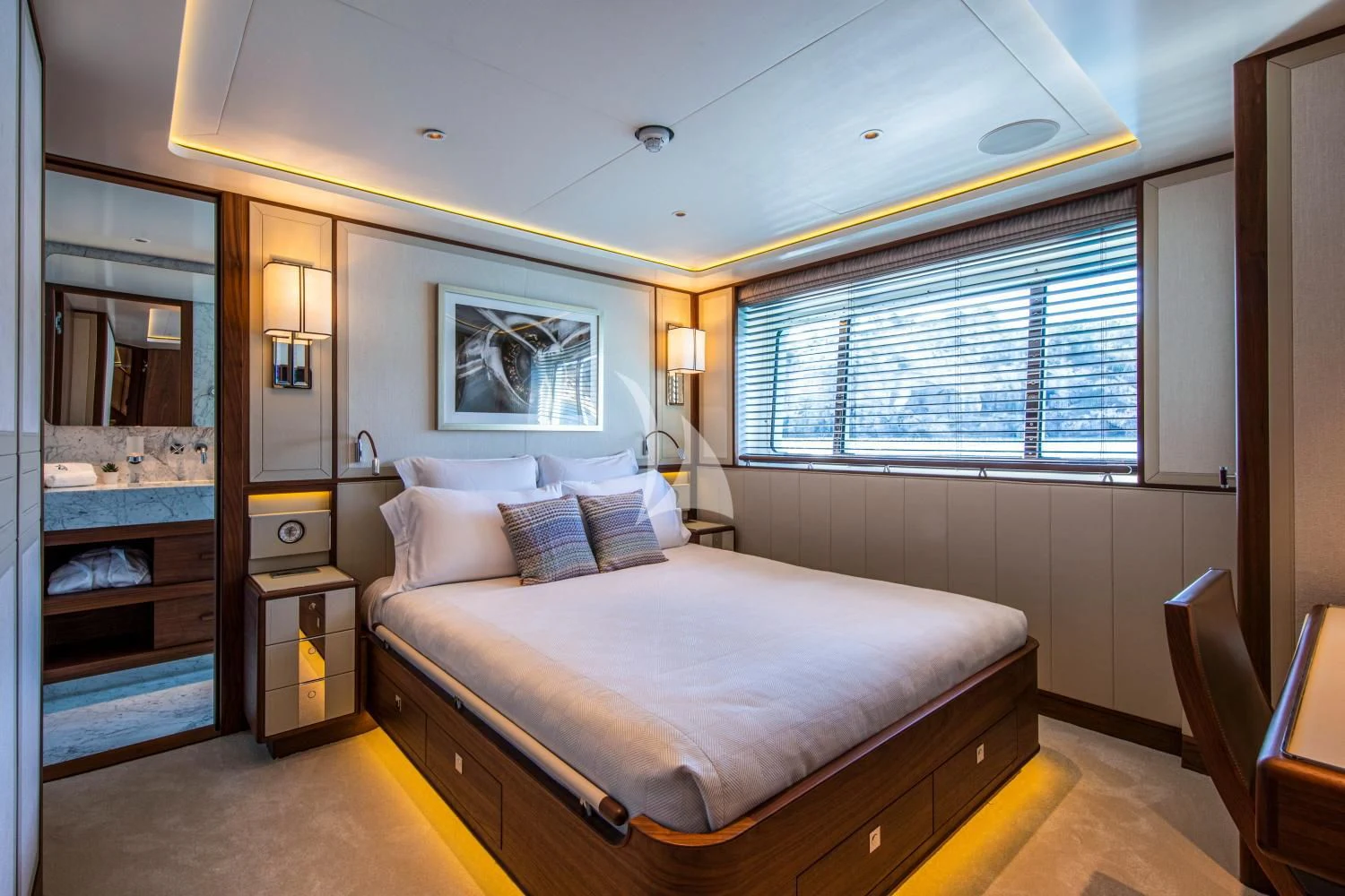 a bedroom with a bed and a mirror aboard DELTA ONE Yacht for Charter