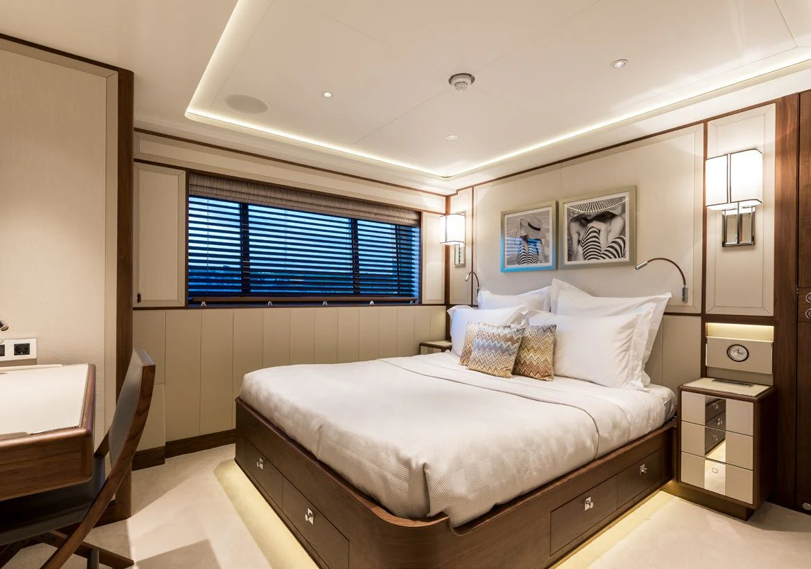 a bedroom with a bed and a window aboard DELTA ONE Yacht for Charter