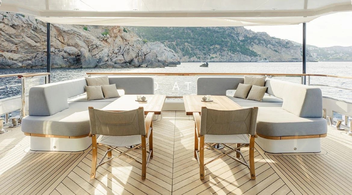 a room with a couch and chairs aboard DELTA ONE Yacht for Charter