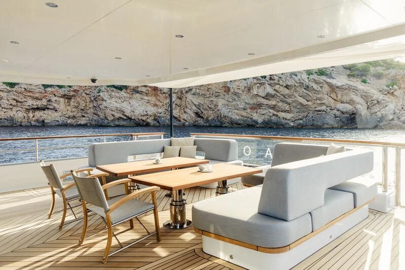 a room with a table and chairs aboard DELTA ONE Yacht for Charter