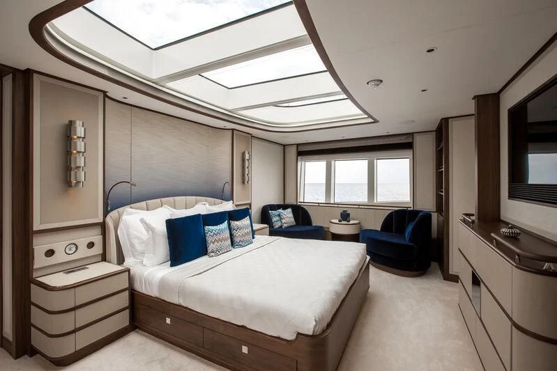 a bedroom with a bed and a desk aboard DELTA ONE Yacht for Charter