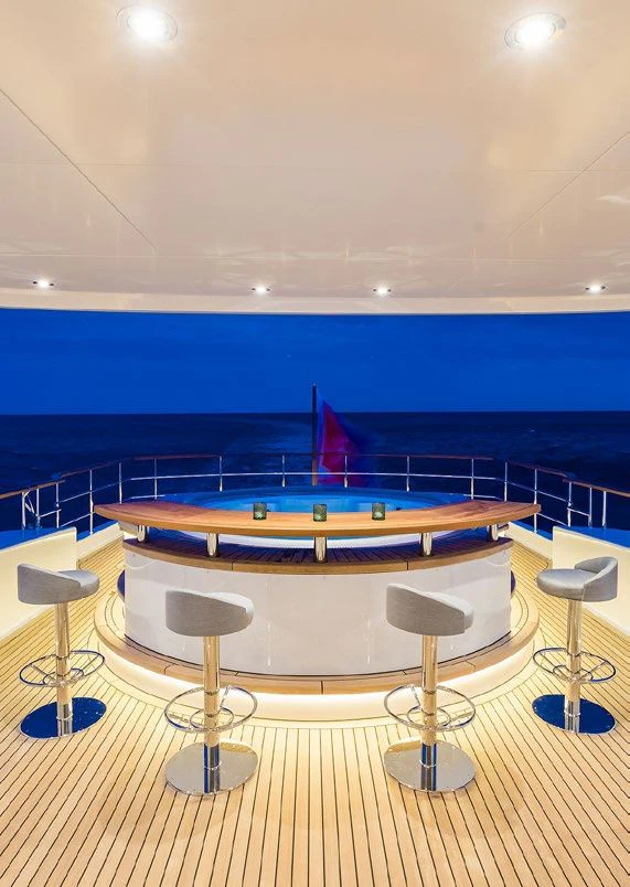 a pool with a table and chairs aboard DELTA ONE Yacht for Charter