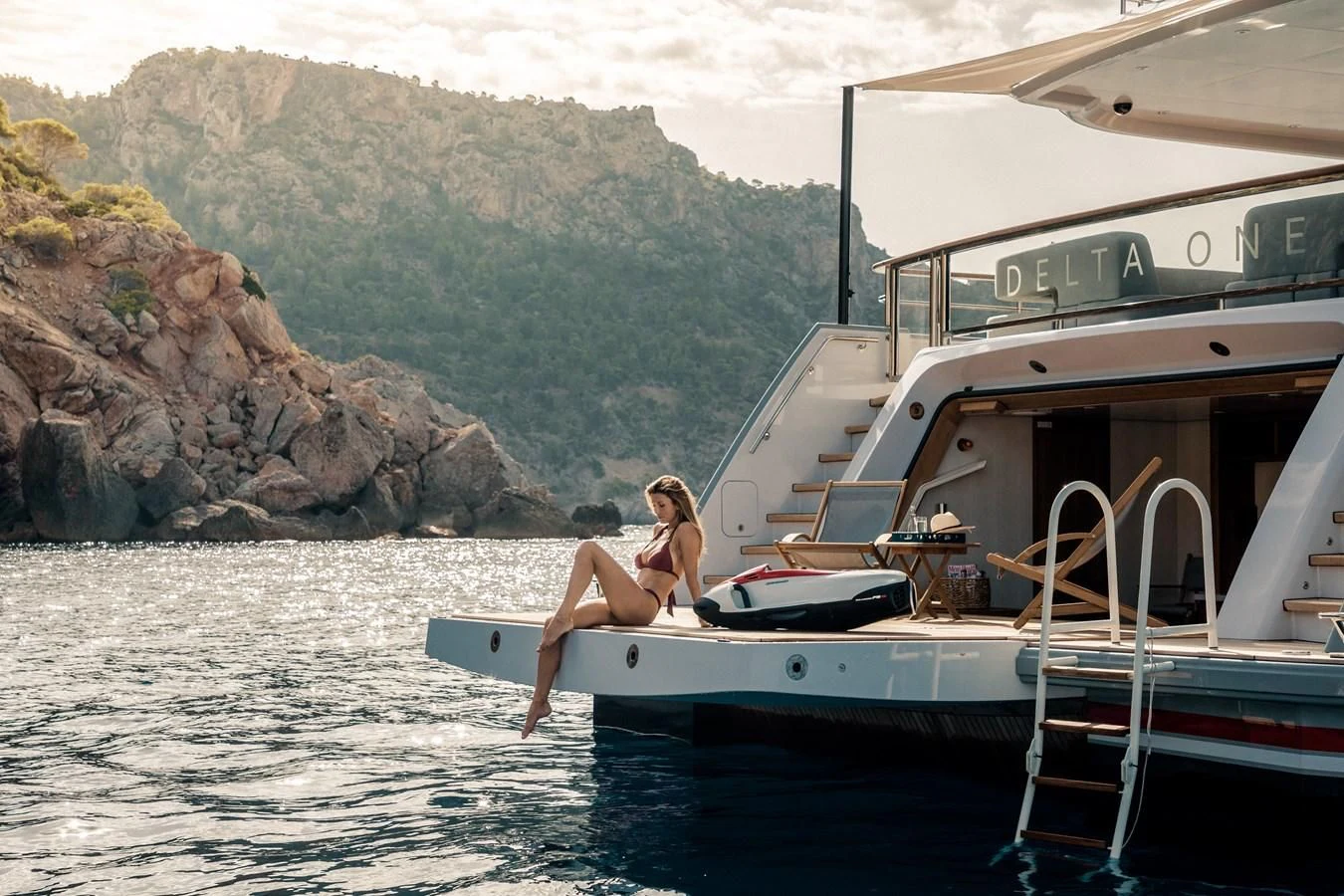 a person sitting on a boat aboard DELTA ONE Yacht for Charter
