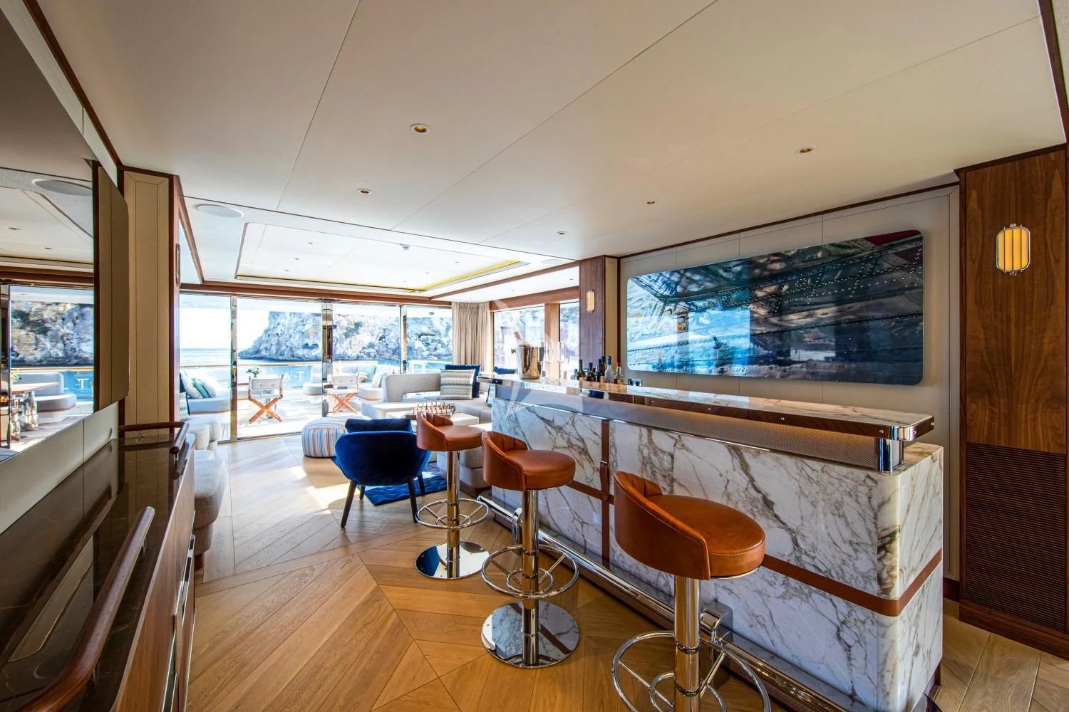 a room with tables and stools aboard DELTA ONE Yacht for Charter