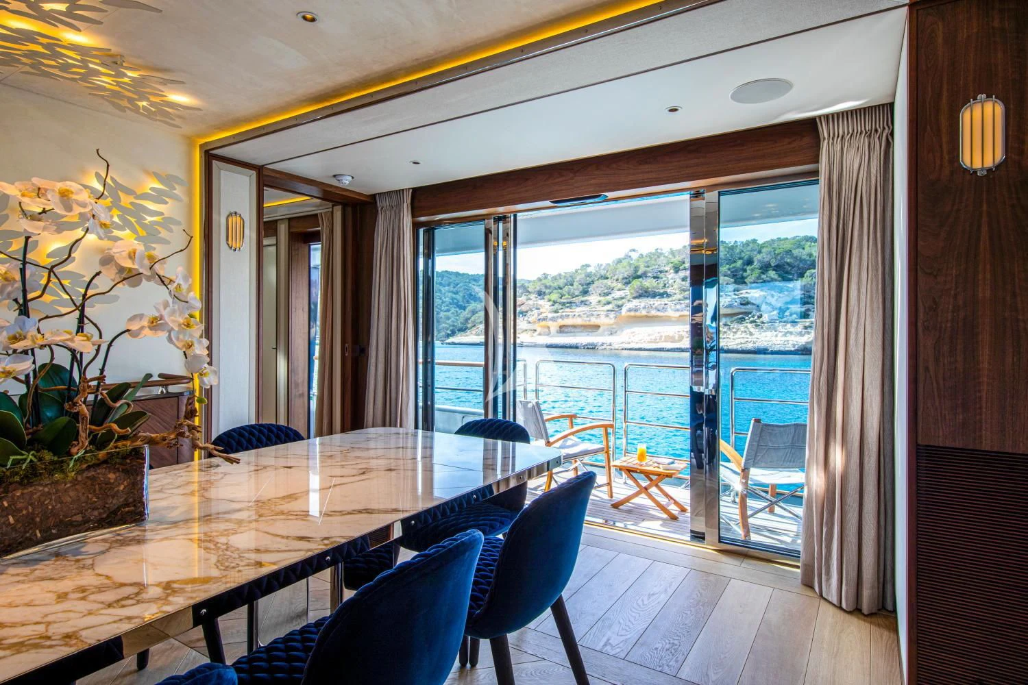 a room with a table chairs and a view of the ocean aboard DELTA ONE Yacht for Charter