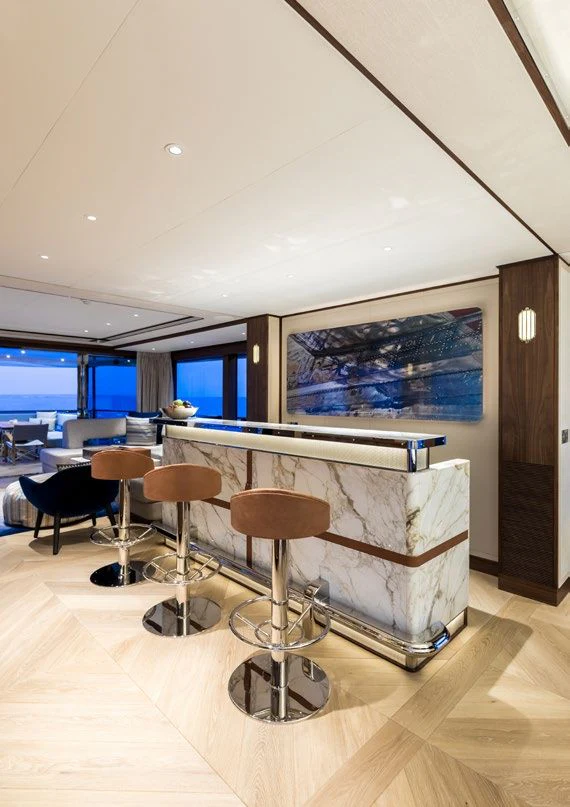 a room with stools and a pool table aboard DELTA ONE Yacht for Charter