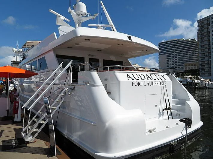 a white boat in a harbor aboard AUDACITY Yacht for Sale