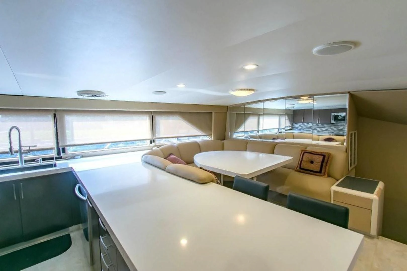a large modern looking room with a large white table and chairs aboard AUDACITY Yacht for Sale