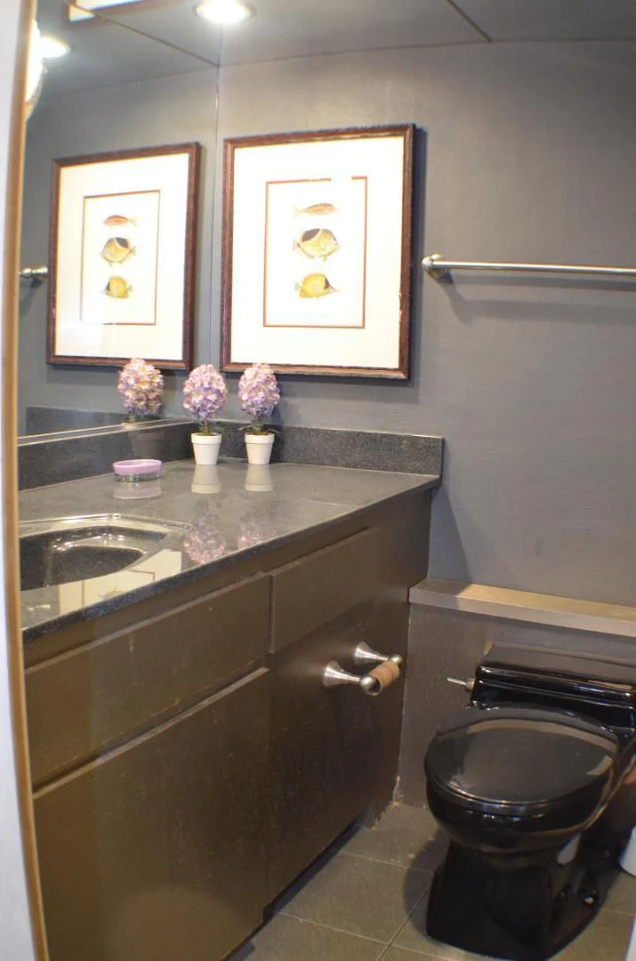 a bathroom with a countertop sink and a mirror aboard AUDACITY Yacht for Sale