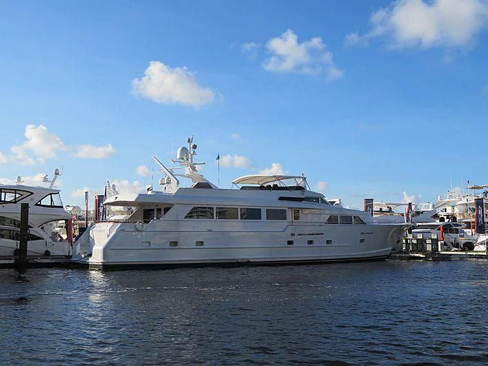 a large white boat in a harbor aboard AUDACITY Yacht for Sale