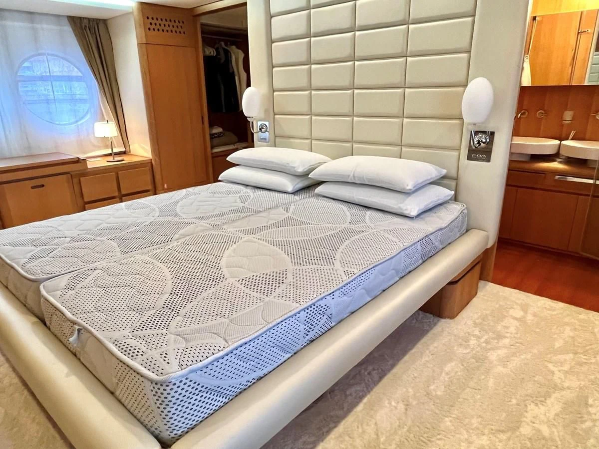 a bed with white sheets aboard AICON 85 Yacht for Sale