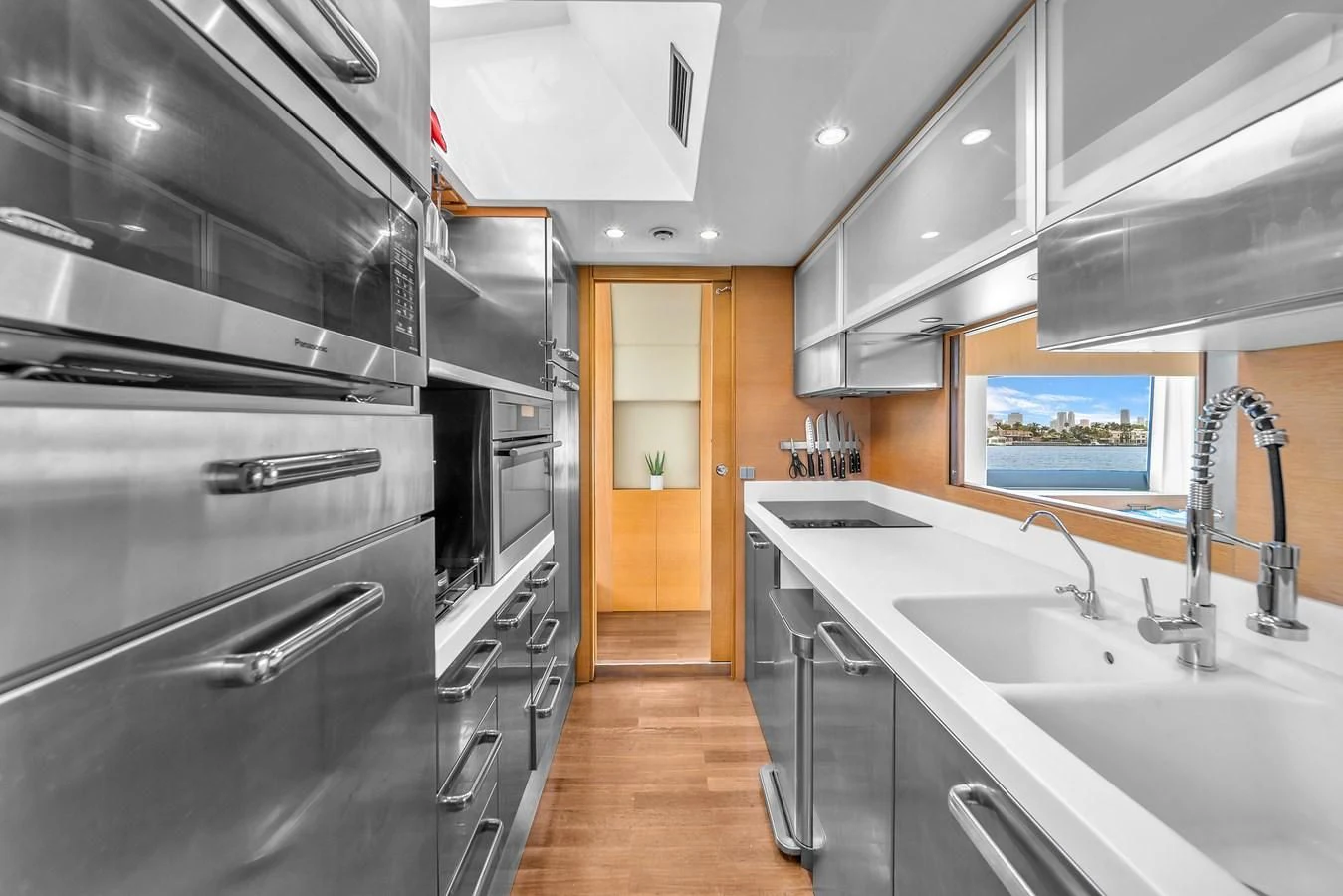 a kitchen with stainless steel appliances aboard AICON 85 Yacht for Sale