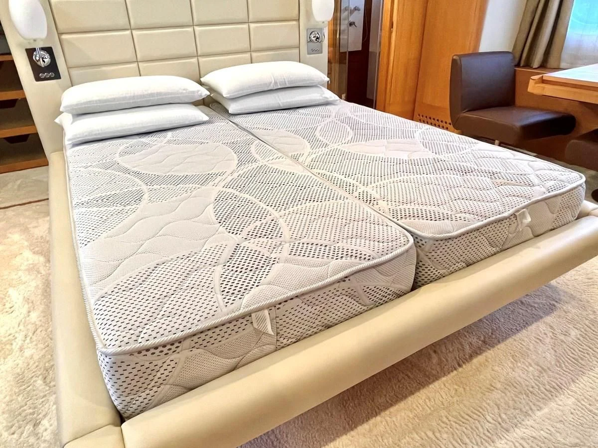 a bed with white sheets aboard AICON 85 Yacht for Sale