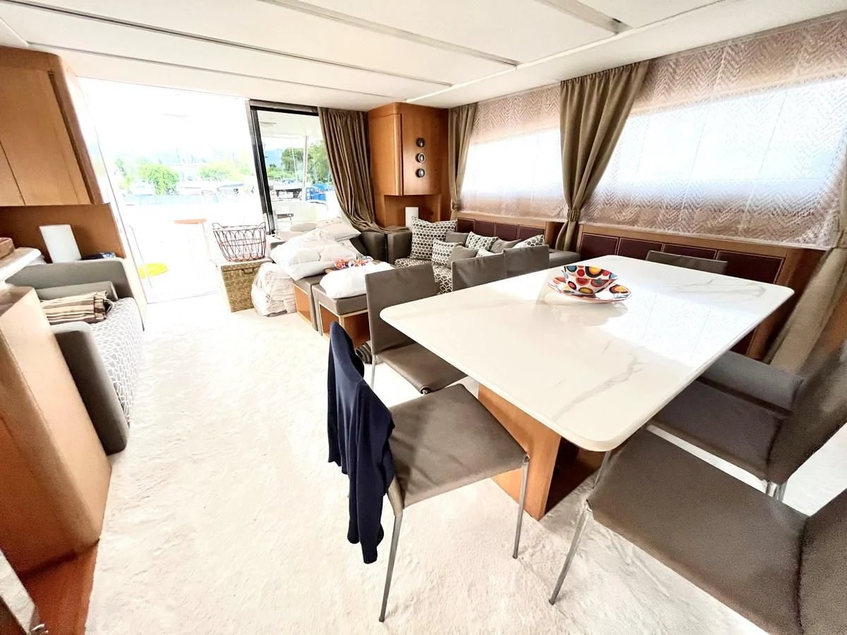 a large living room with a large table and chairs aboard AICON 85 Yacht for Sale