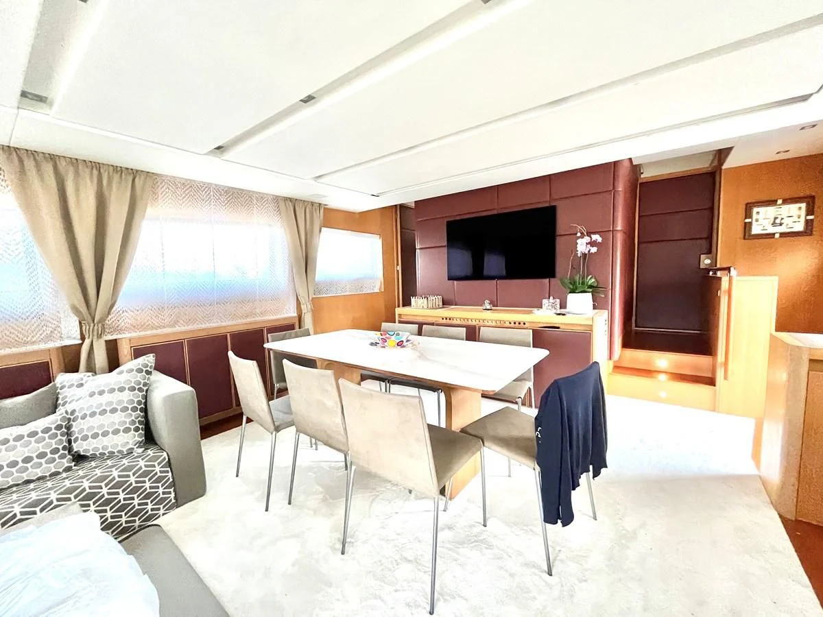 a room with a table and couch aboard AICON 85 Yacht for Sale