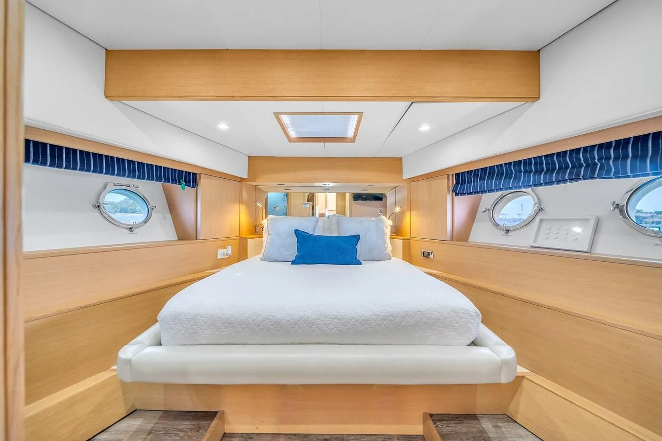 a room with a bed and a clock aboard AICON 85 Yacht for Sale
