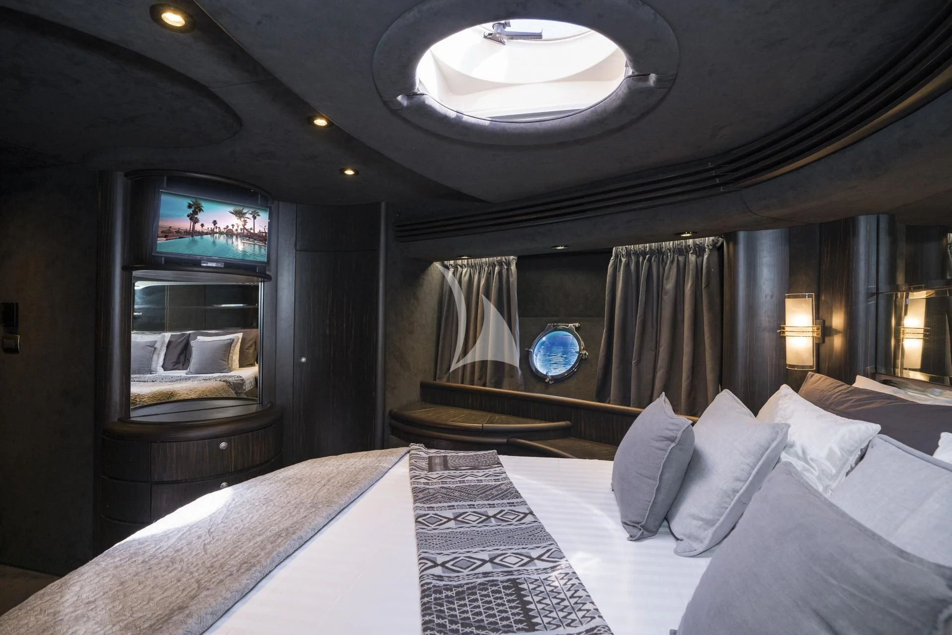 a bed with a large mirror above it aboard MEDUSA Yacht for Charter