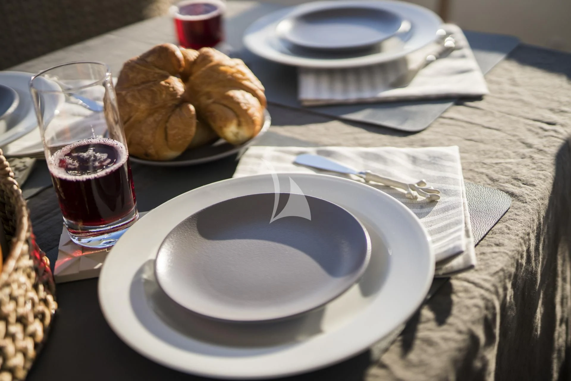 a plate of food and a glass of wine on a table aboard MEDUSA Yacht for Charter