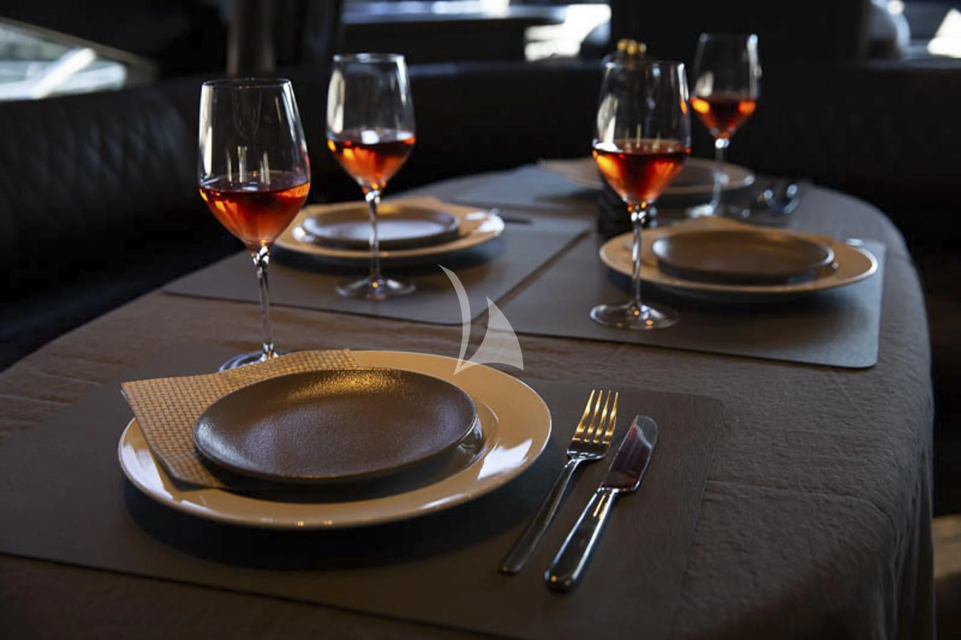 a table with plates and glasses of wine on it aboard MEDUSA Yacht for Charter