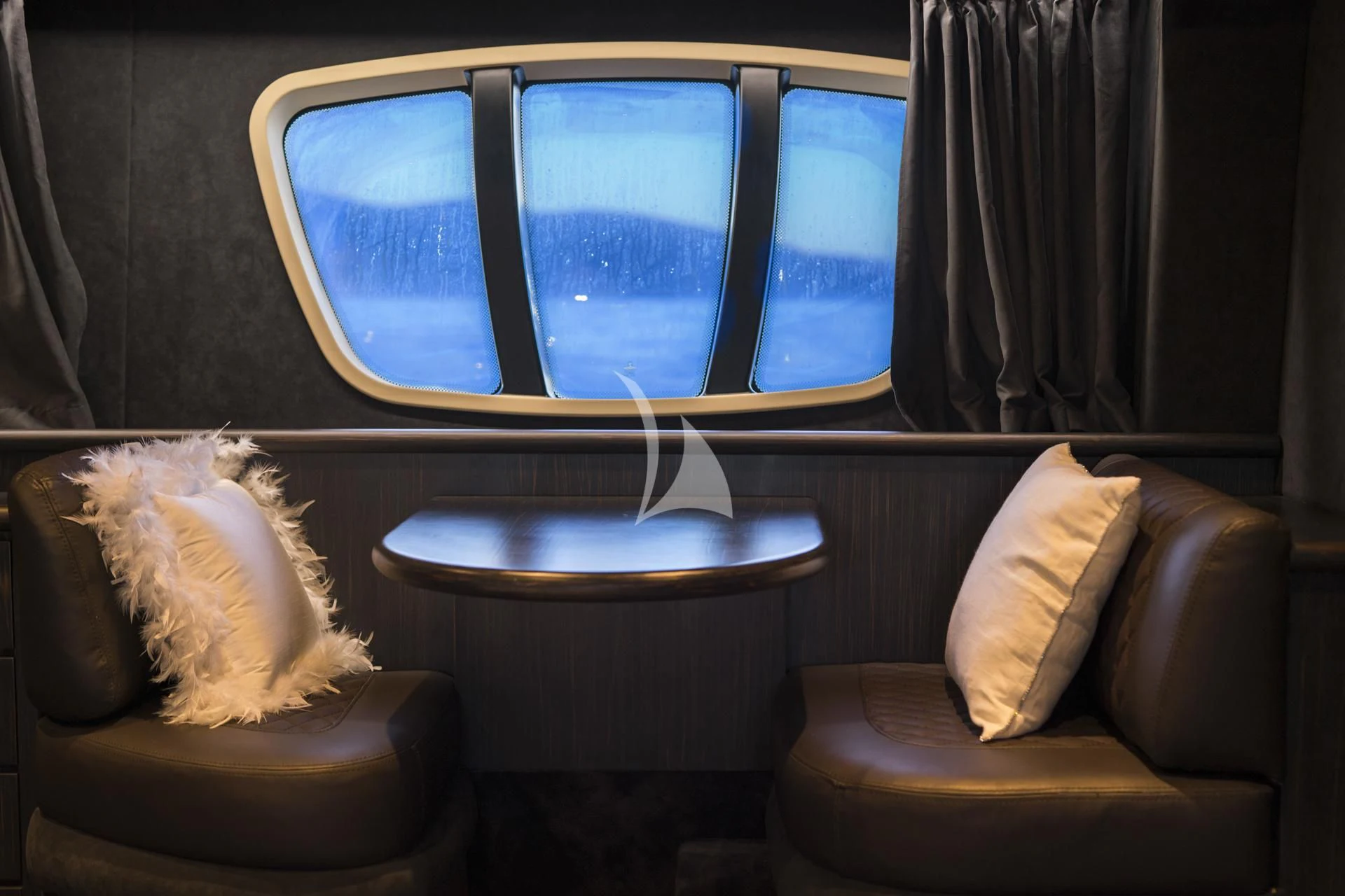 a dog sitting on a chair looking out a window aboard MEDUSA Yacht for Charter