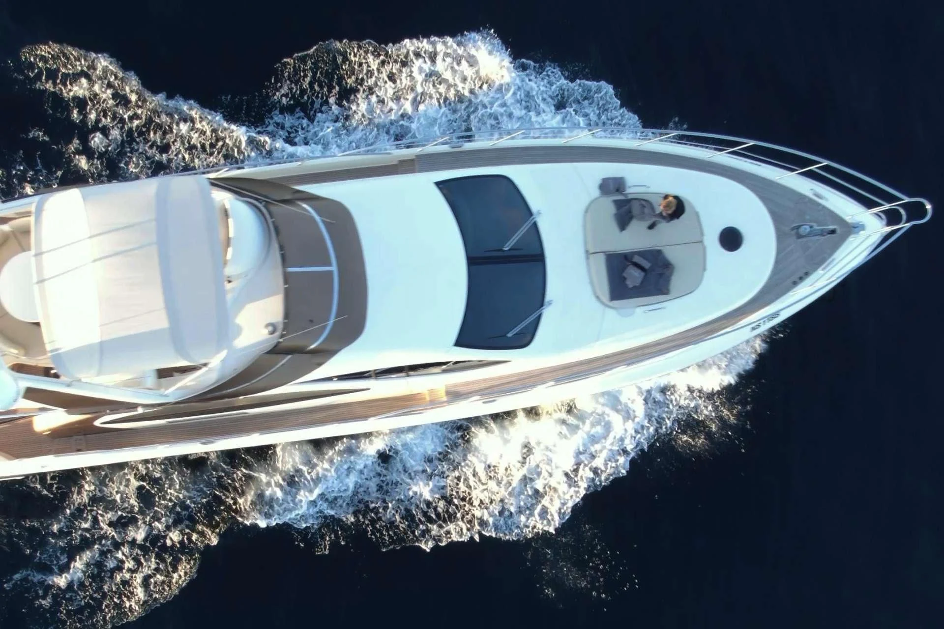 a small white boat in the water aboard MEDUSA Yacht for Charter