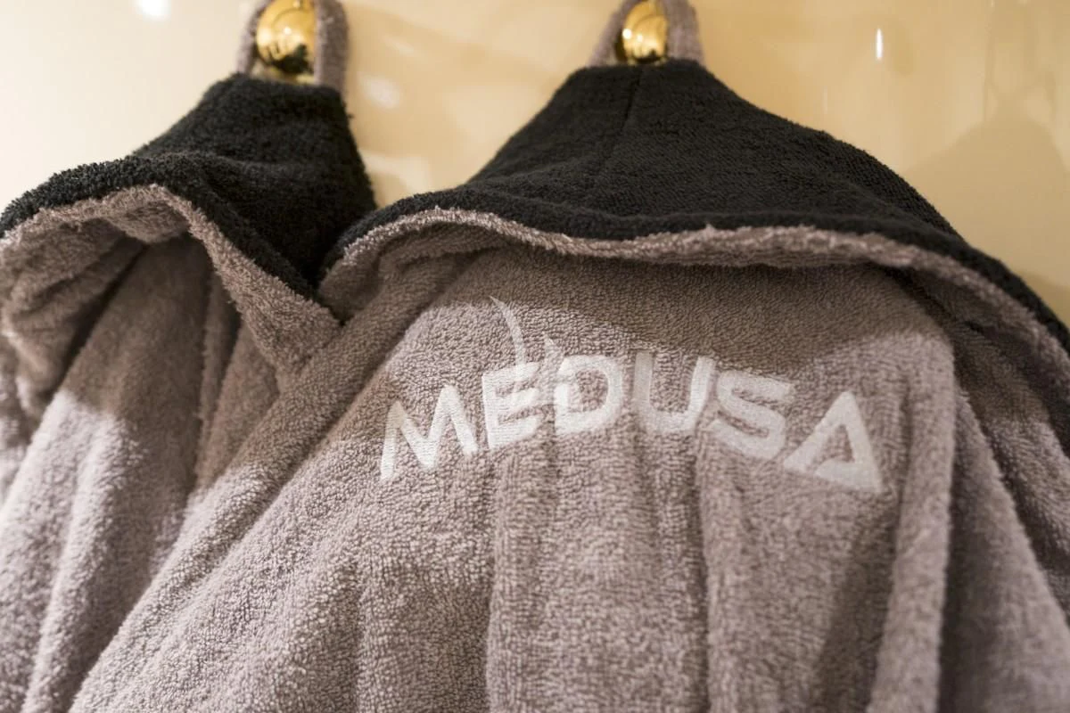 a grey and white sweater with a white message on it aboard MEDUSA Yacht for Charter