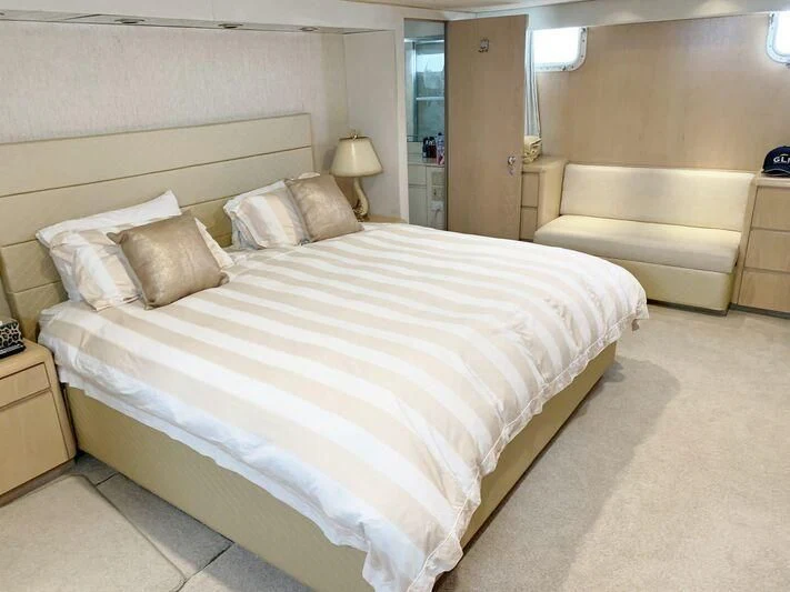 a bed with a white comforter aboard GOOD NEWS Yacht for Sale