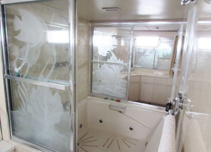 a bathroom with a bathtub and shower aboard GOOD NEWS Yacht for Sale