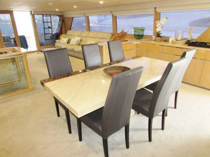 a table with chairs around it aboard GOOD NEWS Yacht for Sale