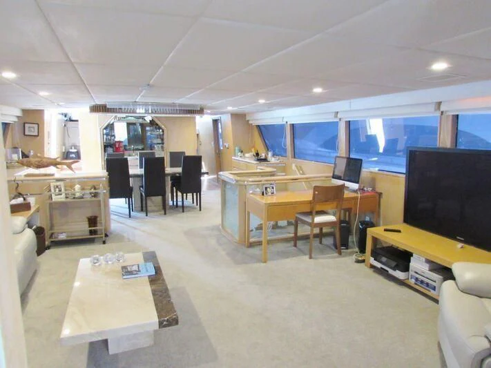a room with a table and chairs aboard GOOD NEWS Yacht for Sale
