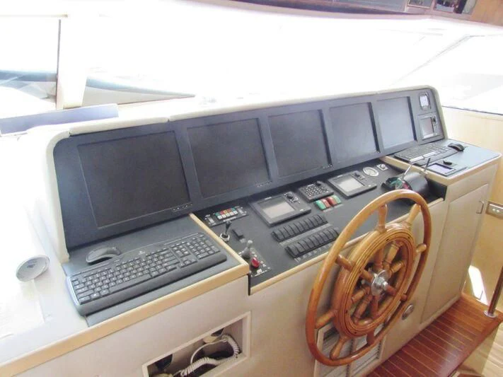 a computer desk with a few computers aboard GOOD NEWS Yacht for Sale
