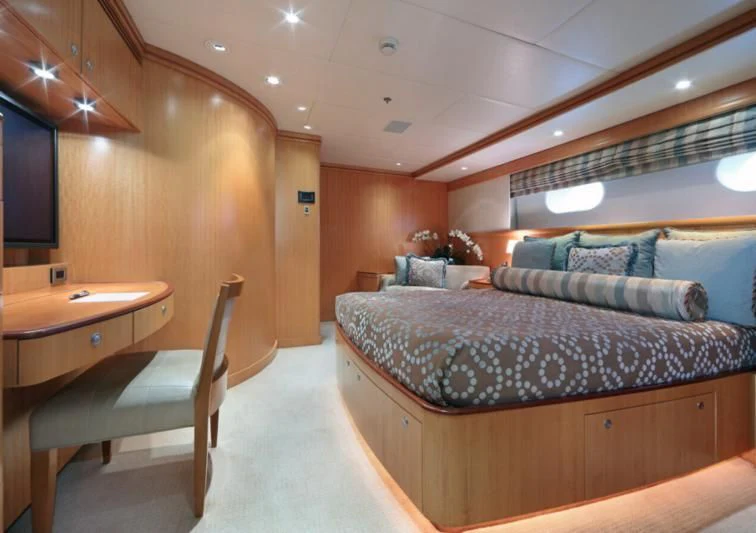 a bedroom with a bed and desk aboard HELIOS 2 Yacht for Sale
