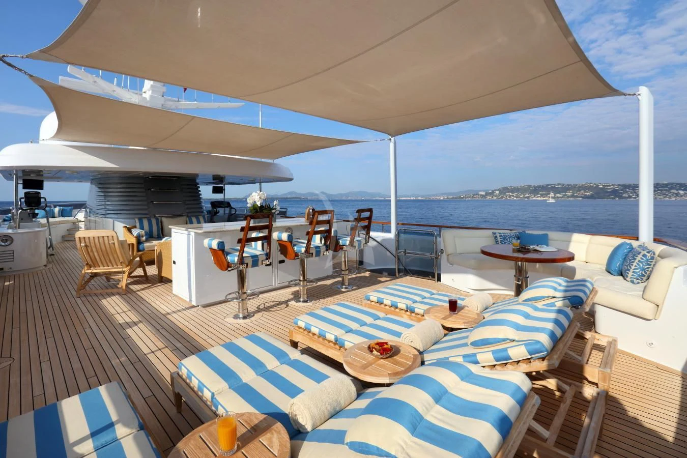 a large lounge area with a large deck and a large body of water aboard HELIOS 2 Yacht for Sale