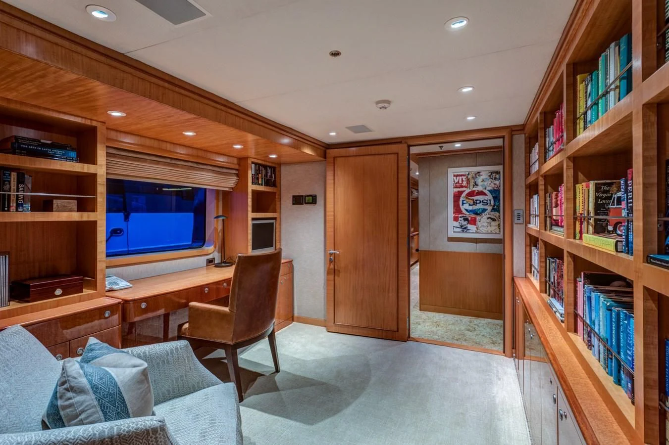 a room with a chair and a bookcase aboard HELIOS 2 Yacht for Sale