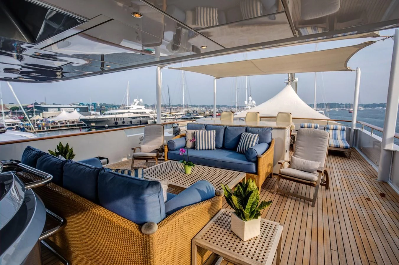 a large lounge area with a large boat in the background aboard HELIOS 2 Yacht for Sale