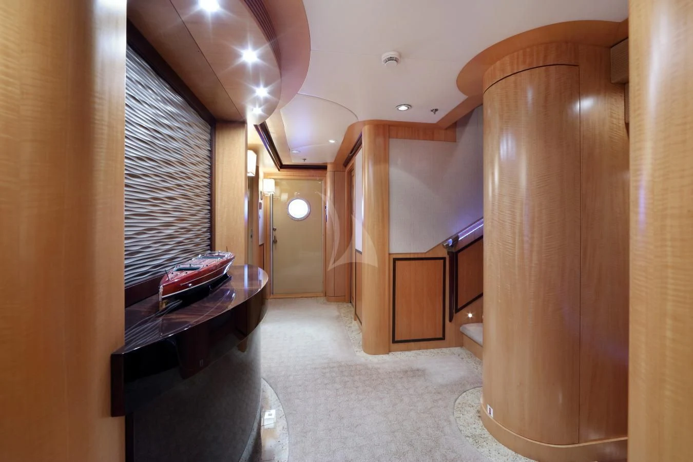 a hallway with a piano and a large wood door aboard HELIOS 2 Yacht for Sale