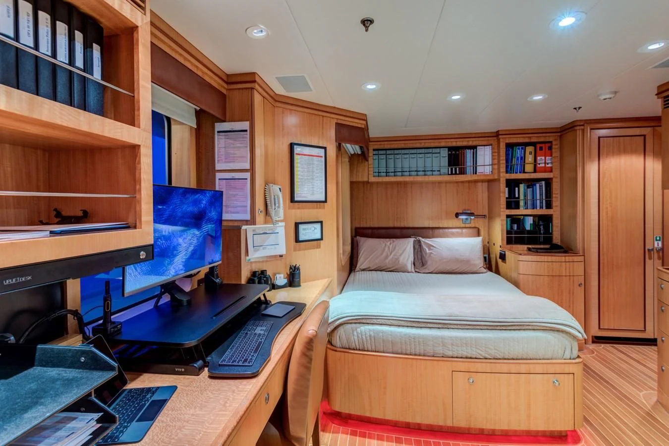 a bedroom with a bed desk and computer aboard HELIOS 2 Yacht for Sale